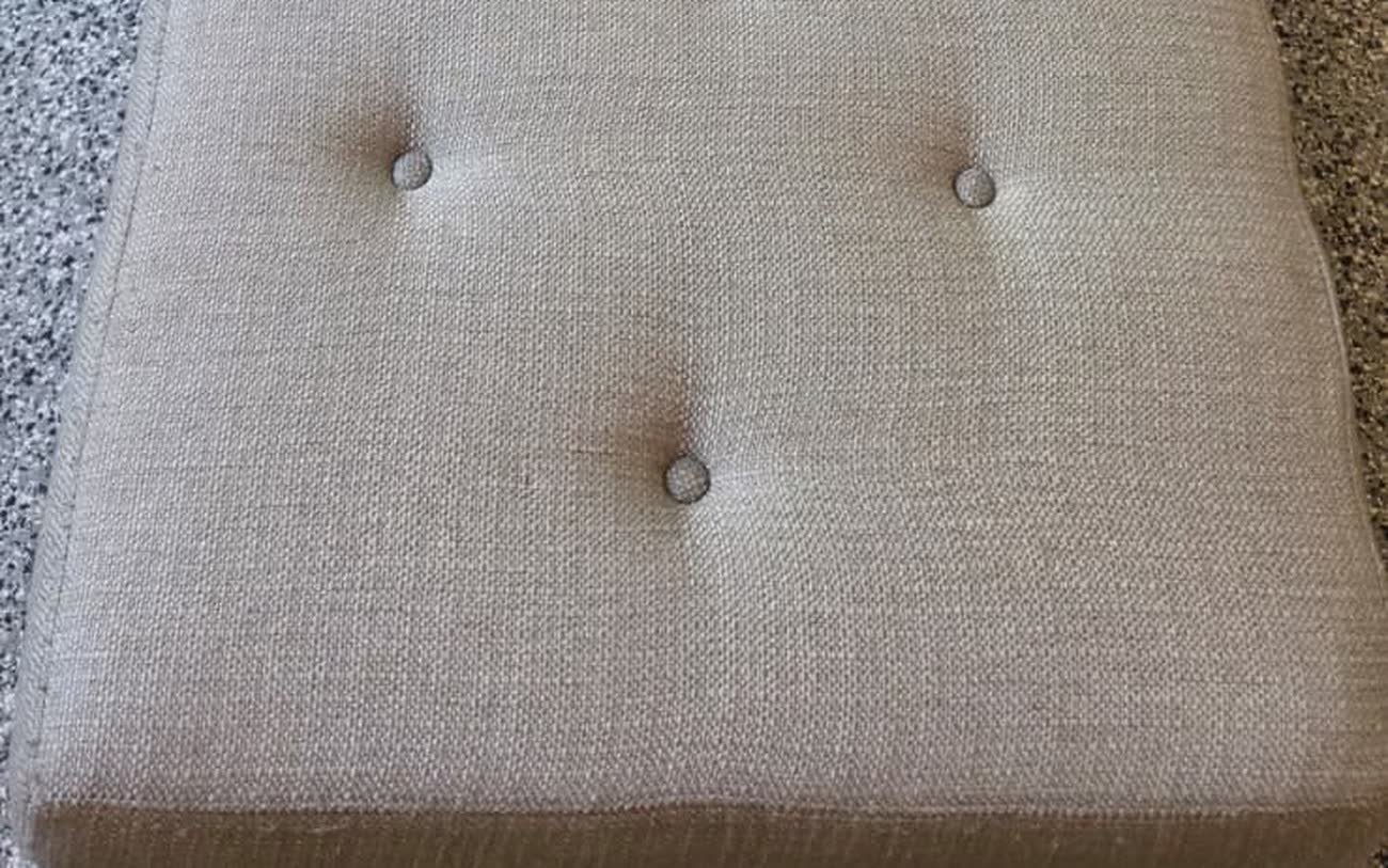 The same tufted bench after cleaning, with the fabric back to an even, bright tone