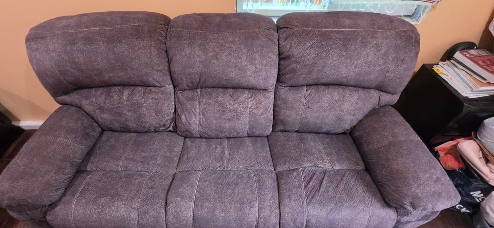 The same reclining sofa after extraction, with the fabric restored to an even, richer tone